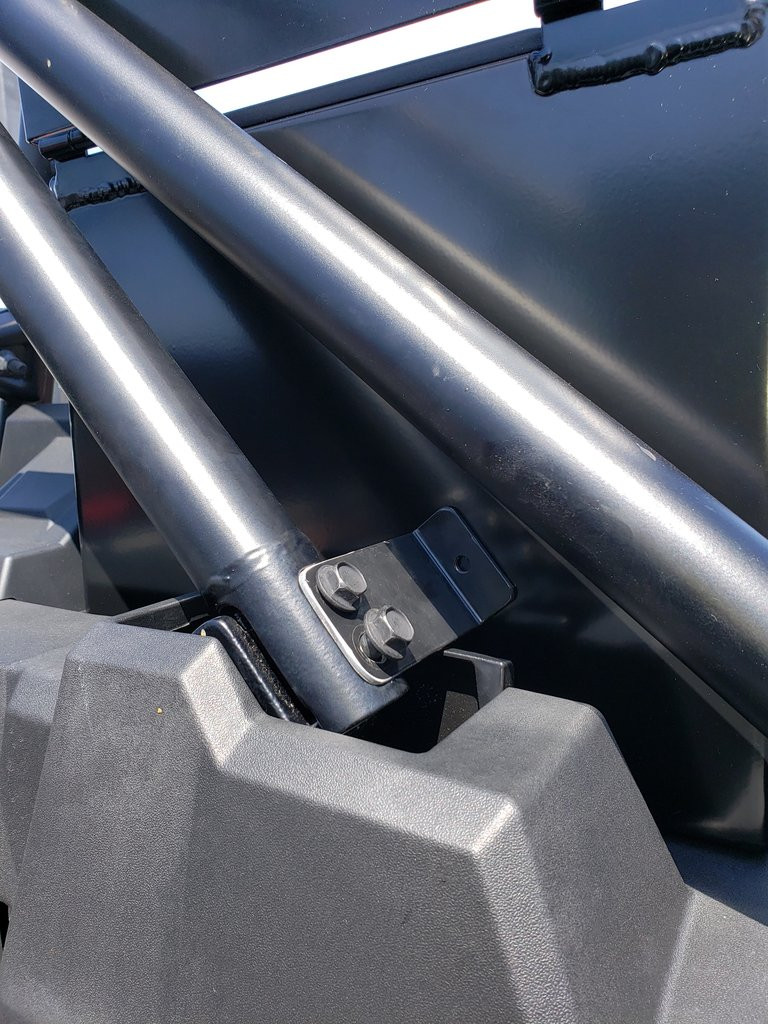 Close-up of the Hi-Standard cargo box mounting bracket bolted to the RZR 1000 Turbo cage bar near the bed