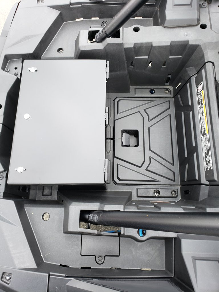 Top-down view of the Hi-Standard security box in the Polaris cargo bed next to the factory storage compartment