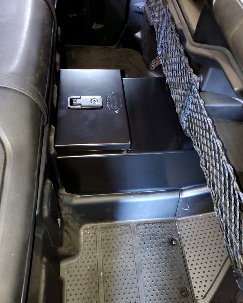 Hi-Standard black steel center console with locking latch installed between the seats of a Honda Pioneer 1000