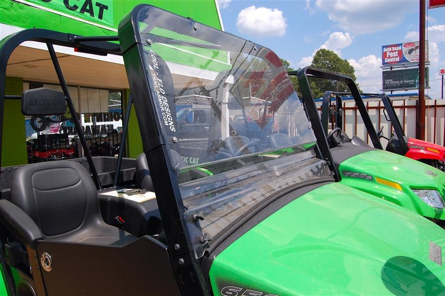 Side view of the green Arctic Cat Prowler with the Trail Armor CoolFlo windshield and square cage in a showroom