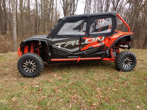 Side profile of a red and black Honda Talon 4 with the Side X Side upper doors closed, clear windows on all four doors