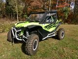 Rear three-quarter view of a green Honda Talon 2 with the Side X Side upper doors installed