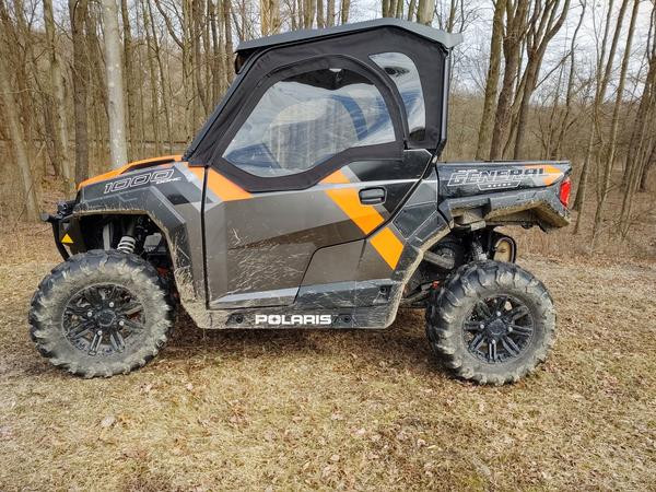Side X Side soft upper door with clear window installed on a gray and orange Polaris General 1000, side profile