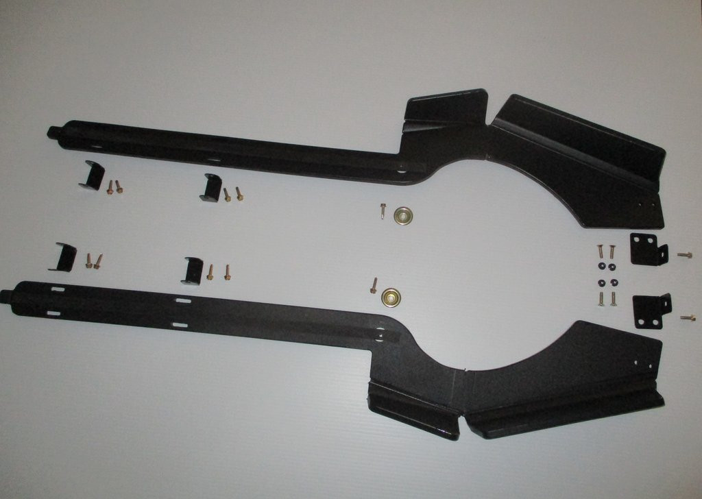 Trail Armor iMpact trailing arm guards for Can-Am Maverick X3, pair of black UHMW guards with hardware laid on white
