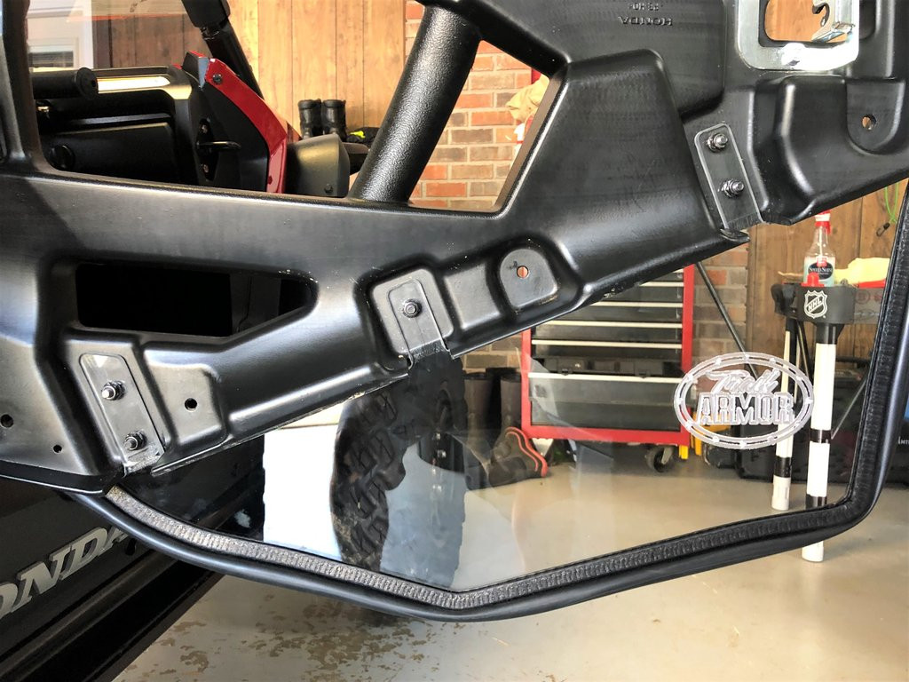 Inside view of the Honda Talon 1000 door frame showing the Trail Armor lower insert mounting brackets