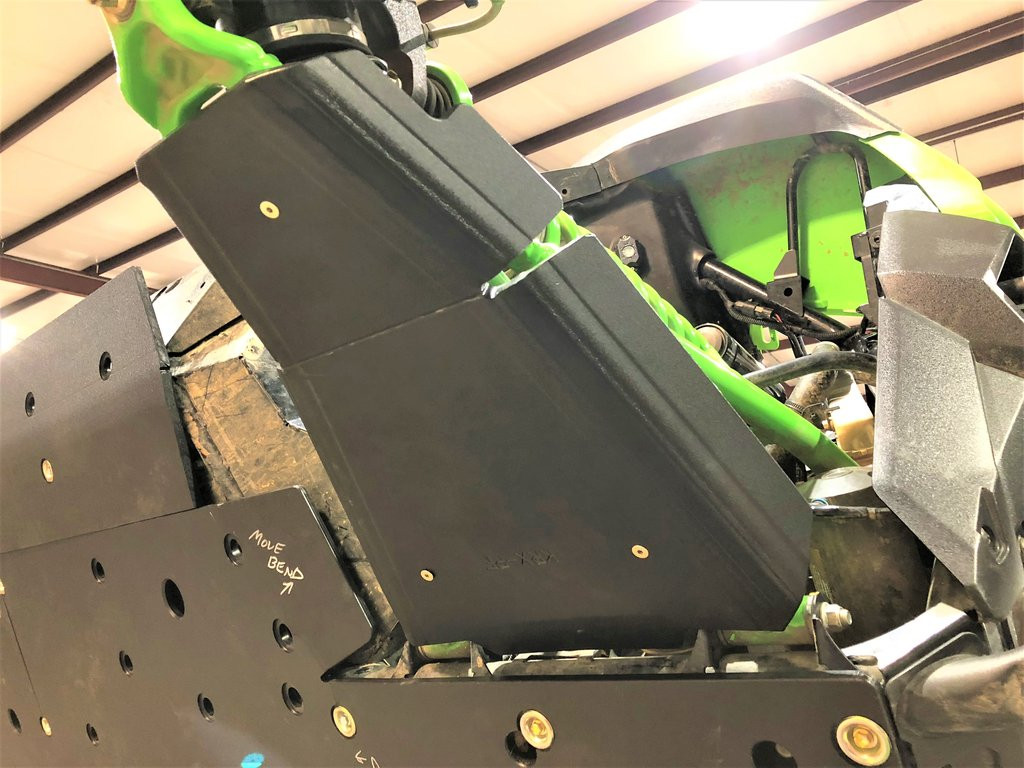 Closer view of the Trail Armor iMpact front guard on the Kawasaki Teryx KRX A-arm above the black skid plate