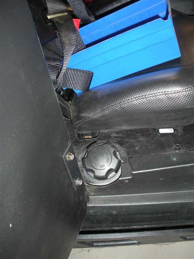 Inside view of the Trail Armor Slimline debris shield next to the Polaris RZR seat, showing the mounting knob