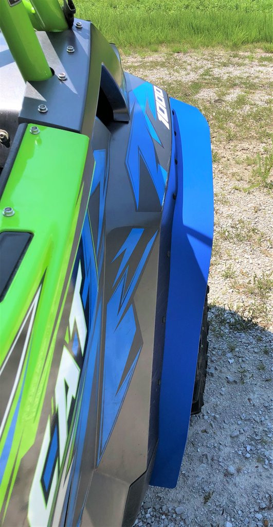Side close-up of the Trail Armor mud flap fender extension on a blue Textron Wildcat XX rear fender