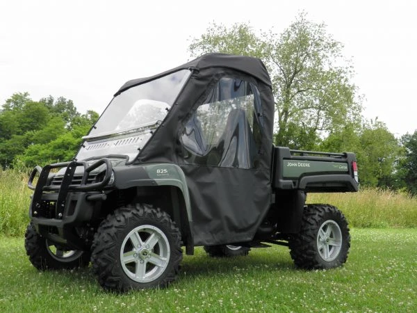 3 Star cab enclosure installed on a green John Deere Gator with hard windshield, front three-quarter view
