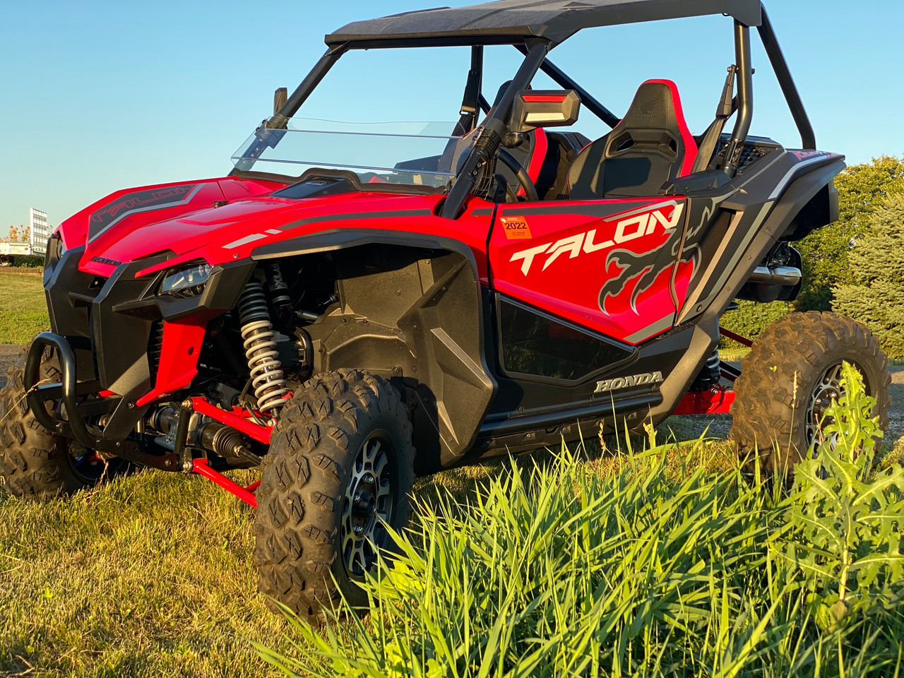 Spike door inserts for Honda Talon 2- and 4-seat: lower door inserts on a red Honda Talon, front corner view