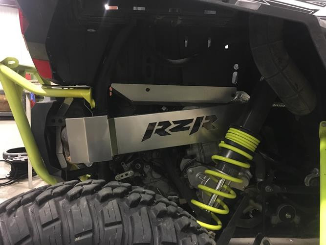 Rear view of a Polaris RZR XP 1000 with the Universal Parts exhaust guard, lime springs and rear tire