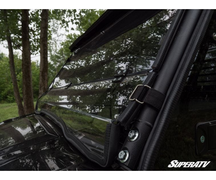Close-up of the SuperATV flip down windshield edge seal and cage clamp on a Kawasaki Mule Pro