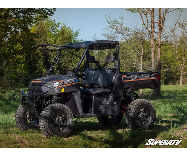 Side view of a Polaris Ranger 1000 parked in the woods with the SuperATV flip windshield closed