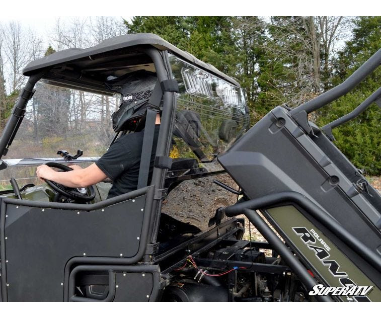 Side view of the black Polaris Ranger 800 with the bed tilted up showing the SuperATV rear windshield behind the seats