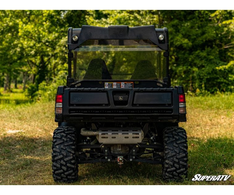 Straight rear view of a John Deere Gator with the SuperATV rear windshield behind the seats above the cargo bed