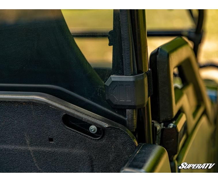 Close-up of the SuperATV rear windshield edge clamp mounted to the John Deere Gator roll cage post