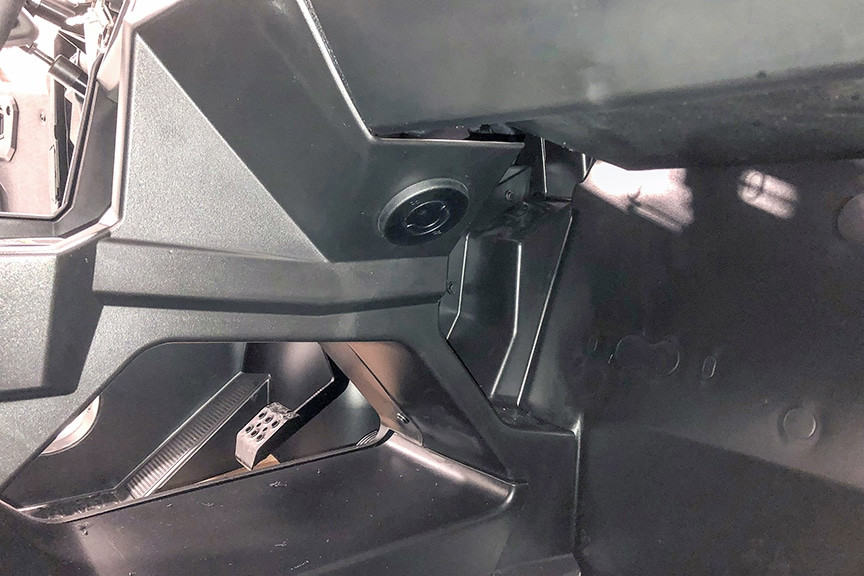 Under-dash view of a round Universal Parts Inferno heater vent and hose routing in the Polaris General 1000