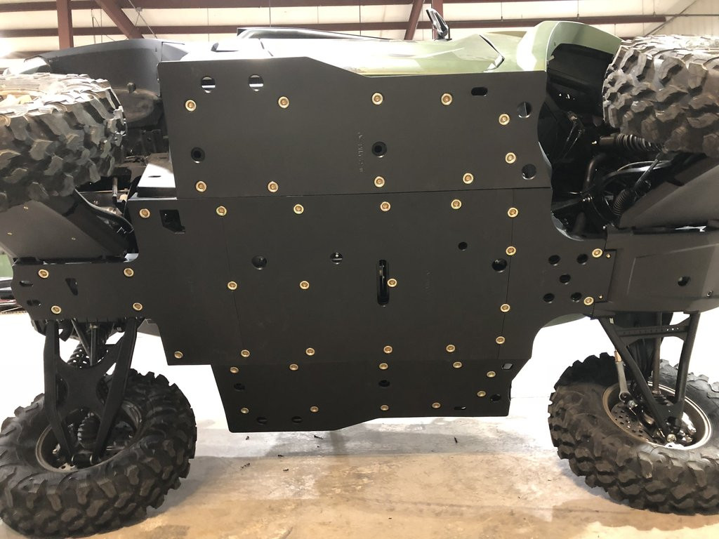Trail Armor full skid plate installed under a green Yamaha Wolverine RMAX2 on a lift, underside view