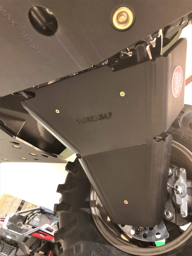Close-up of a Trail Armor A-arm guard bolted to the lower A-arm of the Yamaha Wolverine RMAX beside the tire