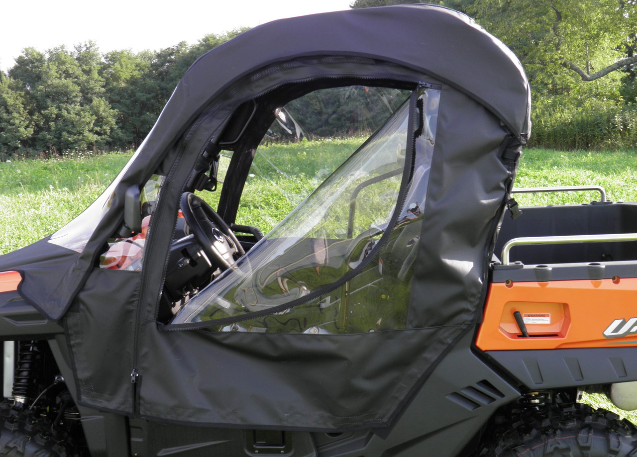 Close-up of the 3 Star enclosure driver door with zippered clear window on an orange machine, bed rail behind