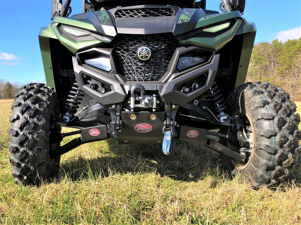 Trail Armor black bash plate installed under the front bumper of a green Yamaha Wolverine RMAX2, front view