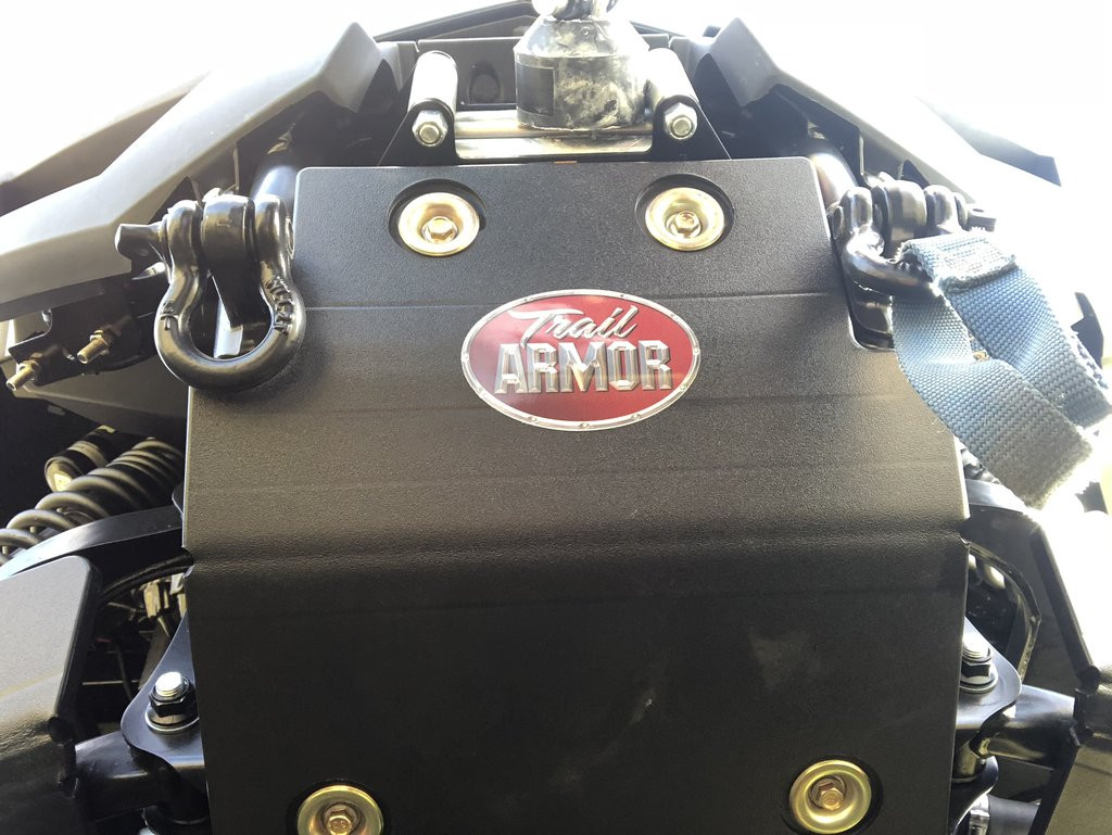 Close-up of the installed Trail Armor bash plate on a Yamaha Wolverine RMAX2 with a D-ring shackle and winch strap