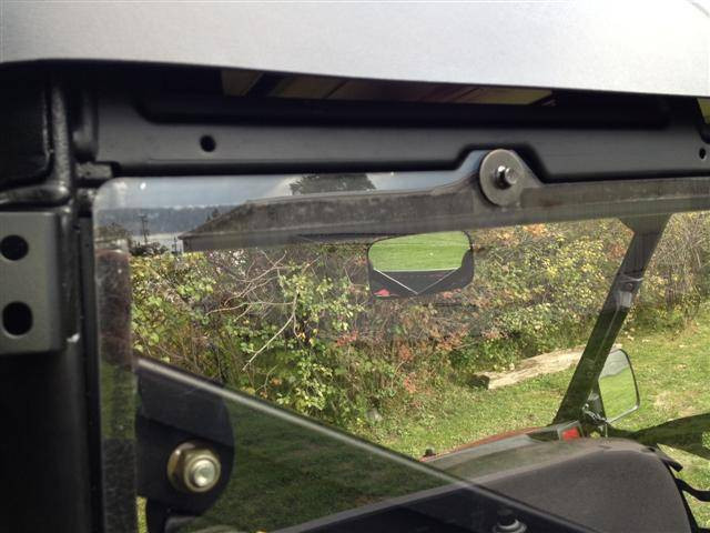Close-up of the Extreme Metal Products rear window upper corner clamp and bolt on the cab frame, seen from outside