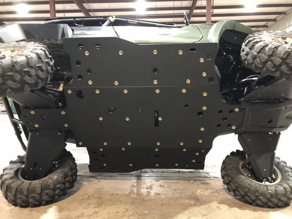 Trail Armor full skid plate set installed under a green Yamaha Wolverine RMAX4, underside view with machine lifted