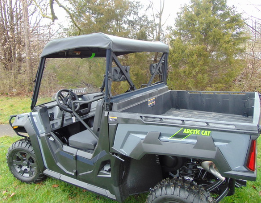 Wider rear three-quarter view of the 3 Star soft top on a gray Arctic Cat Prowler Pro, bed and seats visible