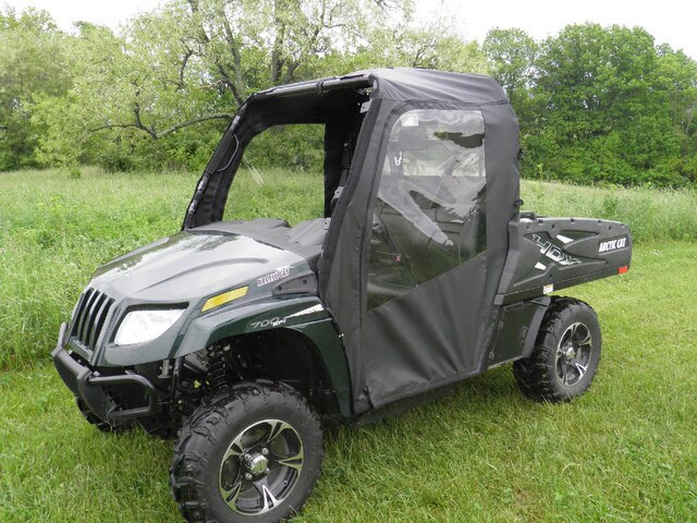 Front three-quarter view of a black Arctic Cat Prowler Pro with 3 Star soft doors and soft top in a field