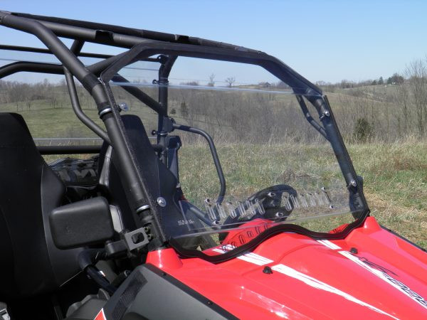 Angled passenger-side view of the 3 Star windshield on the CFMoto ZForce with the rubber edge seal along the hood