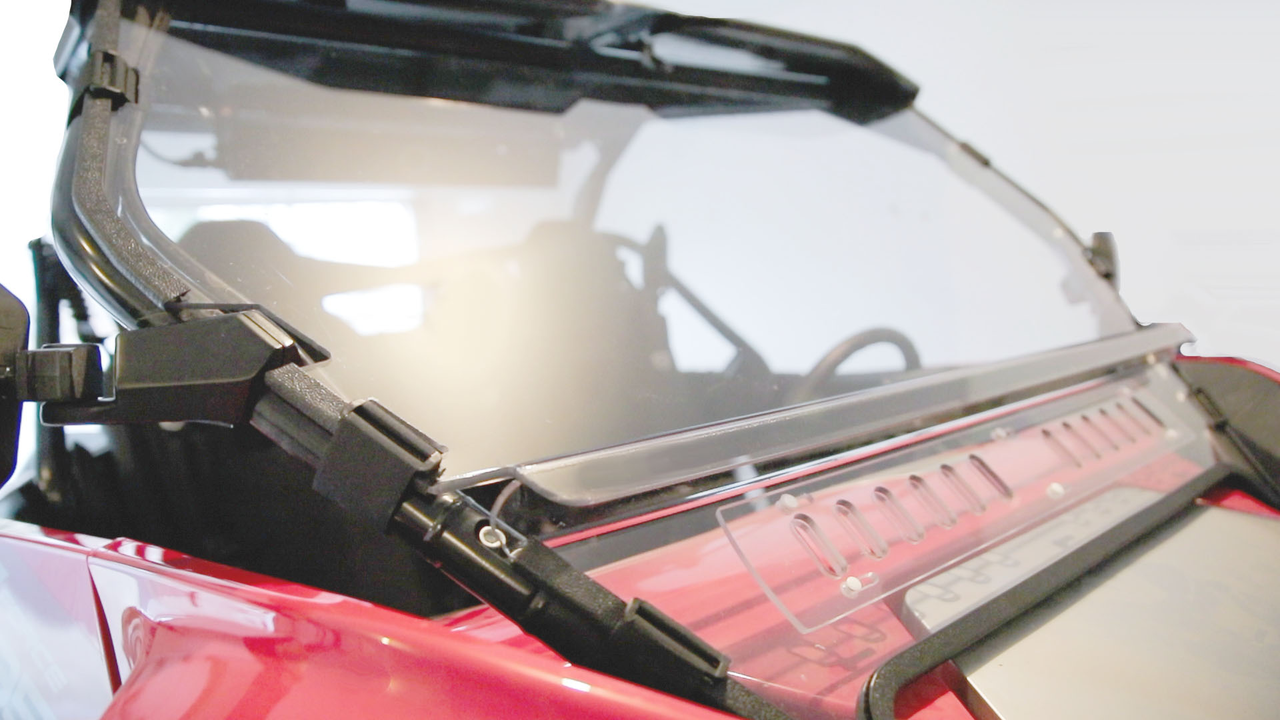 Close-up of the 3 Star windshield lower vent panel and hinge on the hood of a red CF Moto ZForce 950
