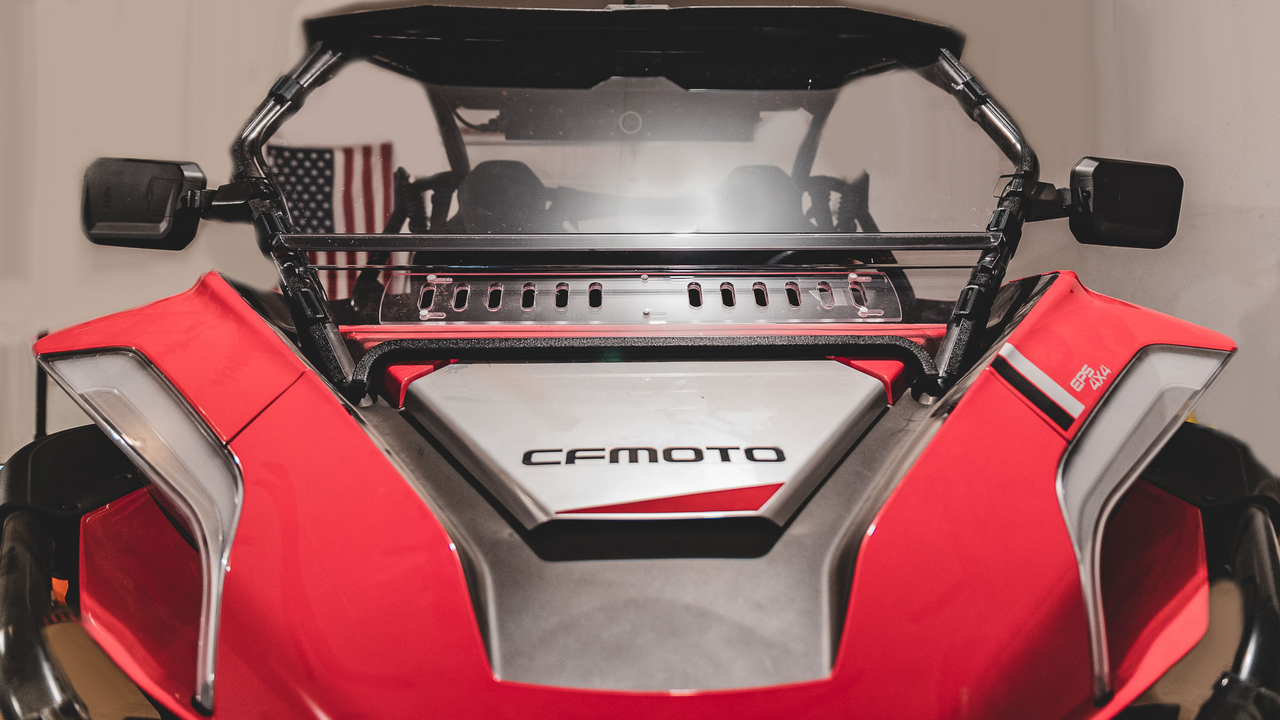 3 Star 2-piece windshield installed on a red CF Moto ZForce 950, front view showing the vented lower panel indoors