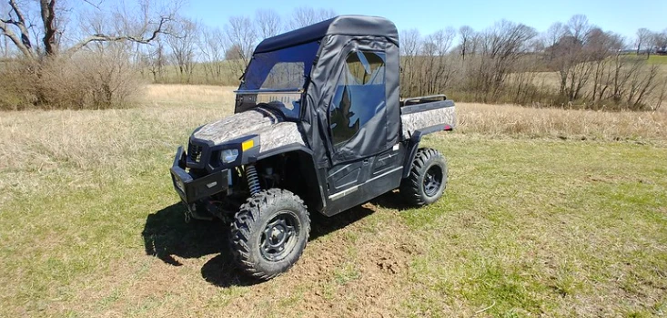 Front three-quarter view of a Hisun Sector fitted with the 3 Star soft doors and rear window kit on a grassy slope