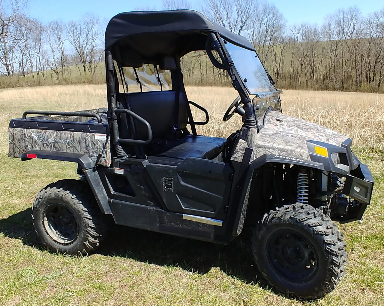 Front three-quarter view of the camo Hisun Sector 550/750 with the 3 Star soft top over the cab