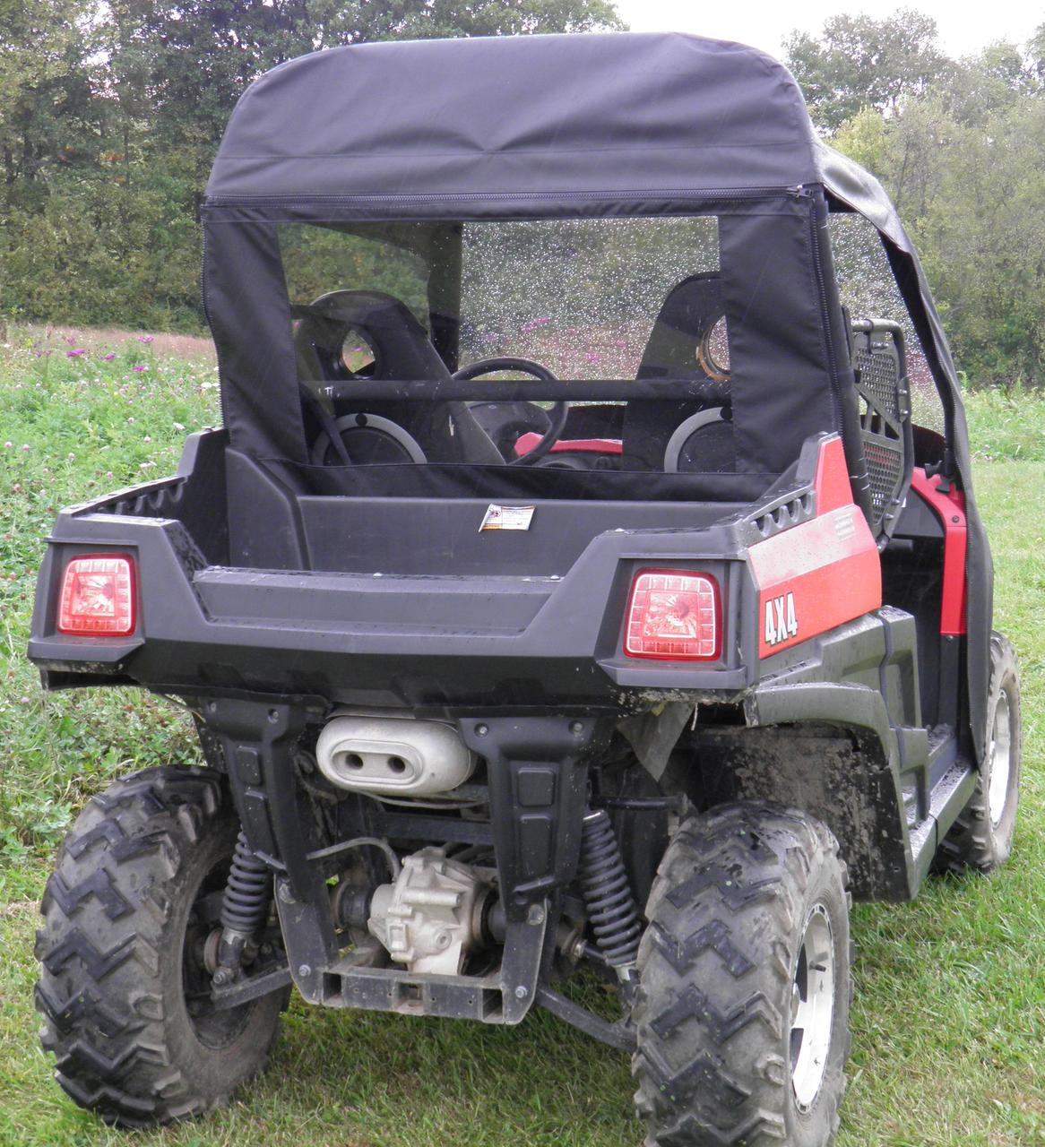 Rear view of a red Hisun 800 with the 3 Star soft top and clear rear window closing off the cab