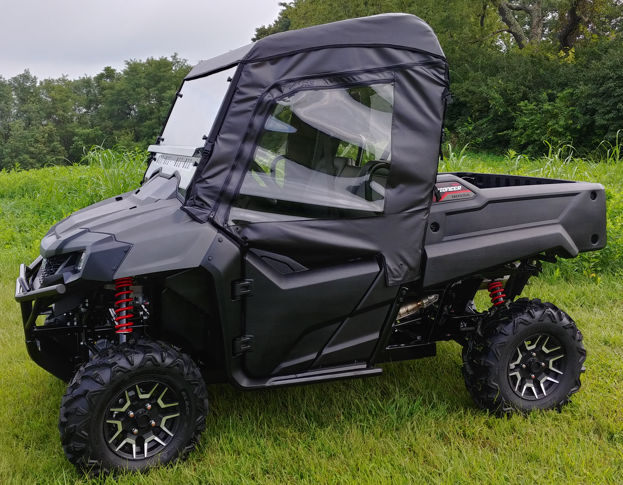 3 Star full cab enclosure with hard windshield on a gray Honda Pioneer 700-2, driver side profile