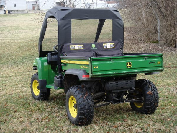 Rear three-quarter view of a John Deere Gator HPX/XUV with the 3 Star soft top and rear window