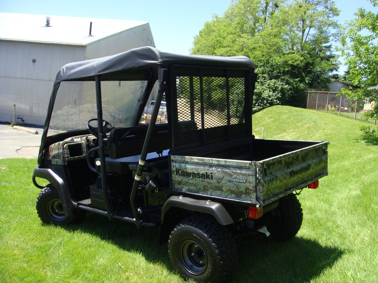 Rear three-quarter view of a Kawasaki Mule 3010 Trans with the 3 Star soft top, windshield and rear window