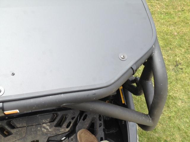 Close-up of the EMP aluminum top rear corner bolted to the roll cage tube of the Can-Am Maverick