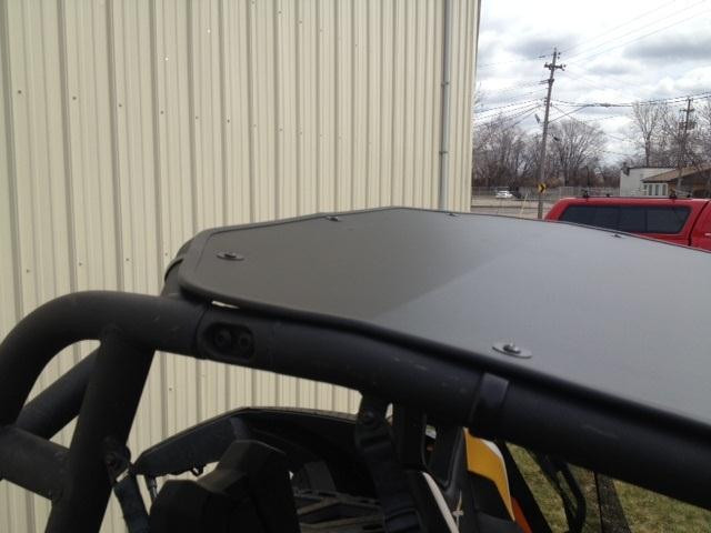 Rear view of the EMP aluminum top on the Can-Am Maverick cage showing the rear edge and mounting bolts