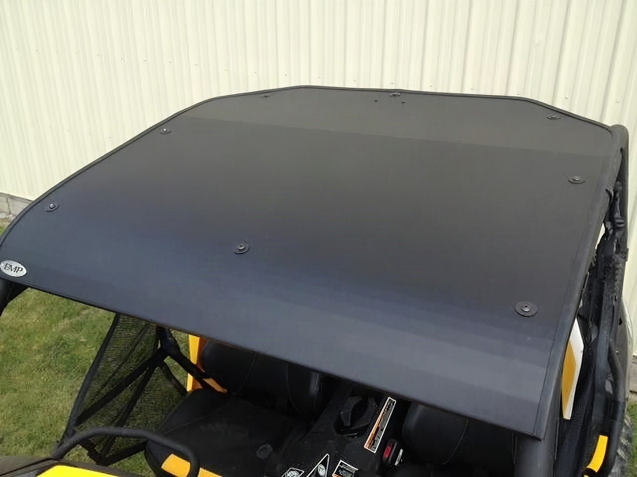 EMP aluminum top installed on a yellow Can-Am Maverick, black roof panel seen from above with front edge bolts