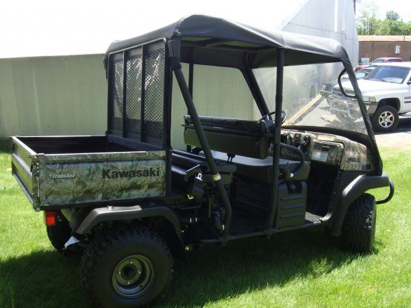 Rear three-quarter view of the 3 Star vinyl top on a camo Kawasaki Mule 4010 Trans with the cargo bed visible