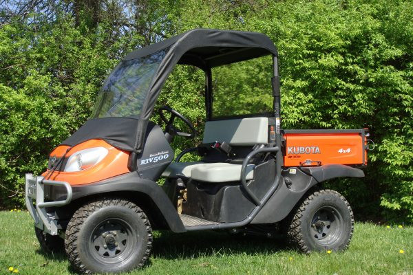 3 Star vinyl windshield and soft top combo installed on an orange Kubota RTV 400/500, front three-quarter view on grass