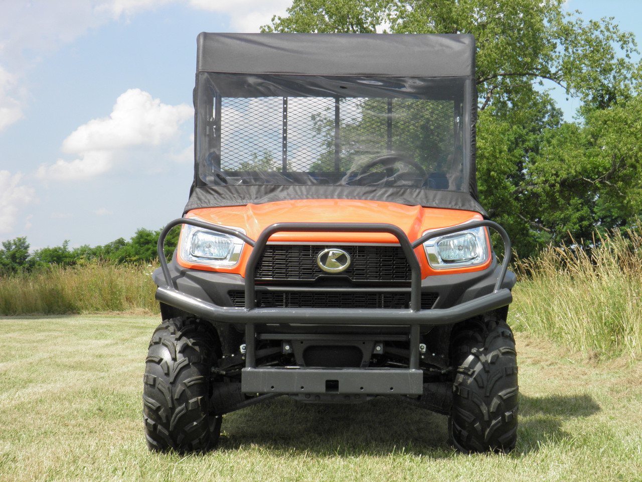 3 Star vinyl windshield and top combo installed on an orange Kubota RTV X1120, front view in a field