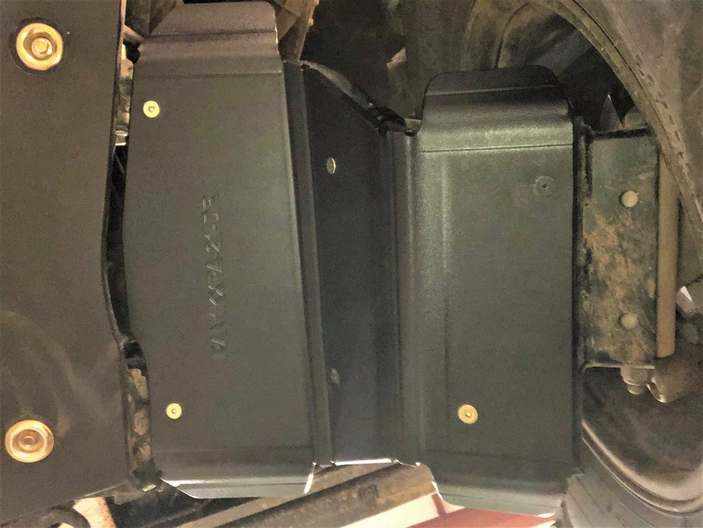 Trail Armor arched A-arm guard installed under the front suspension of a Polaris Ranger XP1000 next to the tire