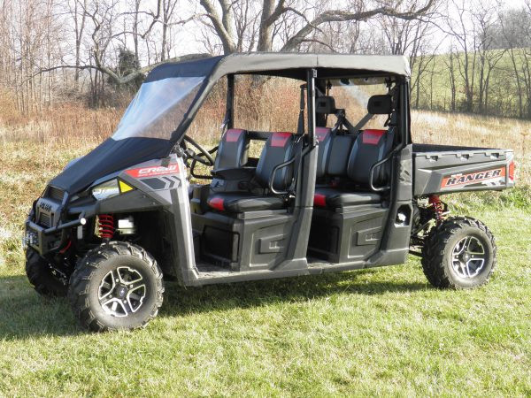 3 Star vinyl windshield and top on a black Polaris Ranger 900 Crew, driver side profile in a field