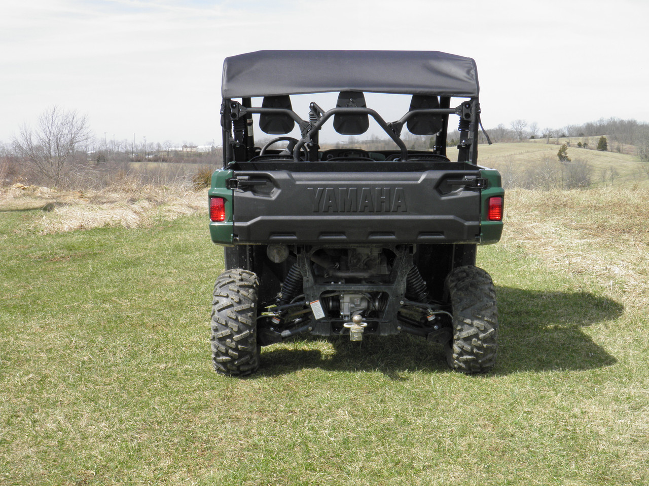 Straight rear view of a green Yamaha Viking with the 3 Star vinyl top installed, three seats visible under it