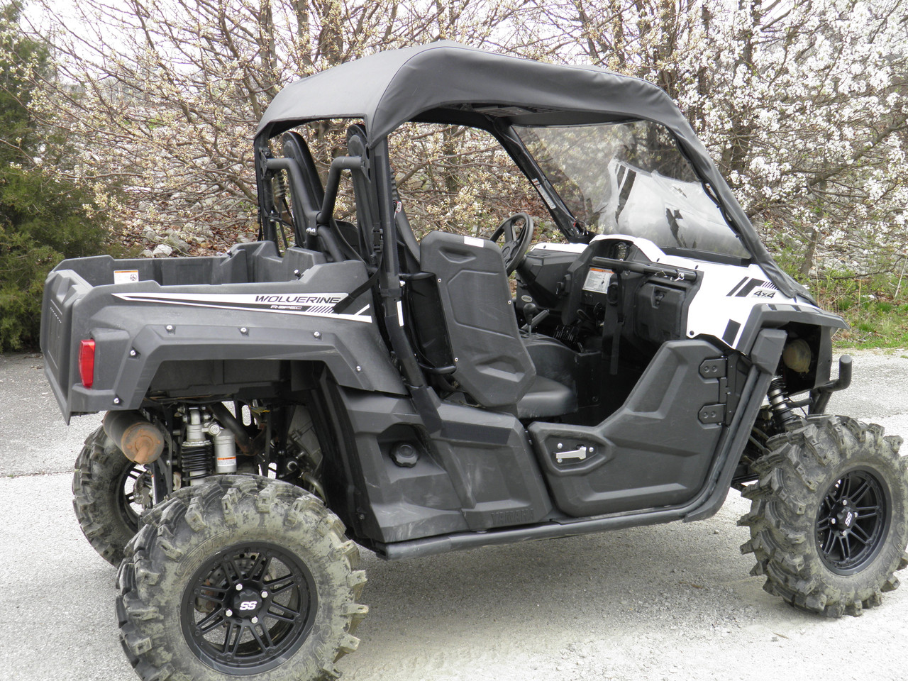 Driver side view of the 3 Star soft top and vinyl windshield combo on a gray Yamaha Wolverine