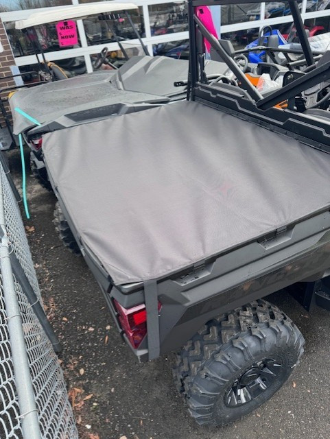 Greene Mountain bed cover stretched over a Polaris Ranger cargo box, angled view from the rear corner